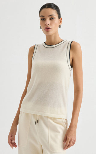 Cream sleeveless cashmere knit top with dark contrast trim at neckline and armholes