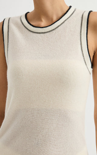 Sleeveless cream knit top with dark contrast trim at high round neckline