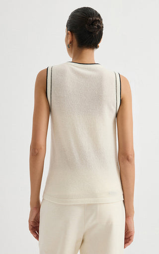 Back view of cream sleeveless knit top with dark contrast trim at neckline