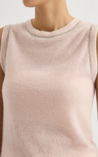 Close-up: light pink sleeveless knit top with contrast trim at crew neckline