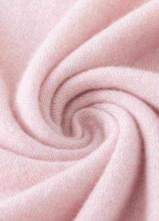 Light pink cashmere knit fabric close-up with soft ribbed texture