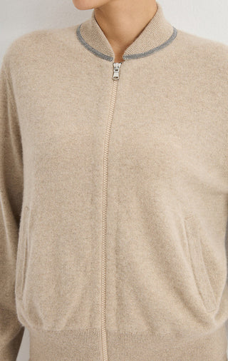Camel zip-front knit jacket close-up with stand collar and metal zipper pull