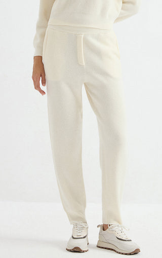 Ivory wool ribbed knit jogger pants with elastic waist and tapered cuffs