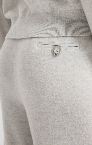 Light grey cashmere pants with waistband detail and small heart-shaped button
