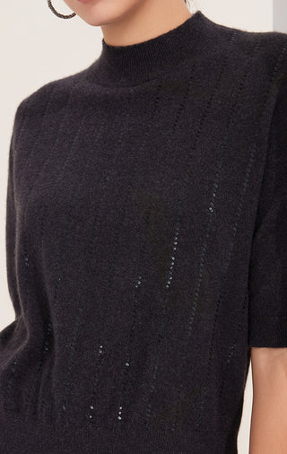 Front close-up of black cashmere mock neck top with vertical sequin stripe detail