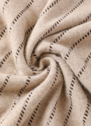 Close-up of camel cashmere fabric with shimmering sequin stripe detailing