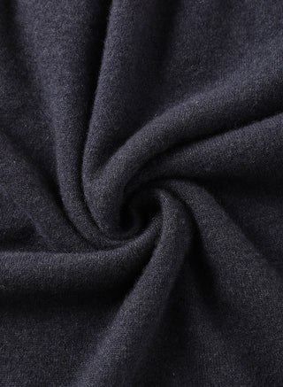 Black cashmere knit fabric close-up, soft texture visible