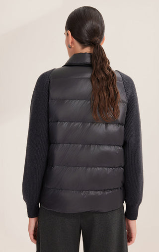Back view of black down shirt jacket with horizontal quilting; knit sleeves visible at sides