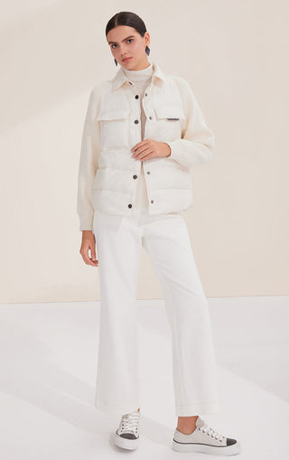 White down shirt jacket with knit sleeves and snap front; women’s length styling with trousers
