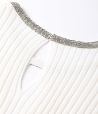 Close-up of white ribbed knit sweater collar trim and small keyhole cutout opening