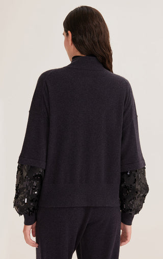 Back view of black knit cardigan with embellished sleeve cuffs and button placket.