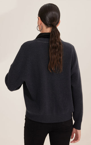 Back view of black wool cardigan with ribbed texture and draped hem