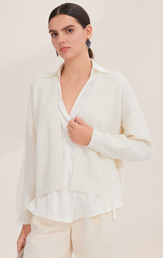 White wool cardigan with open front, ribbed knit texture and layered ruffle hem