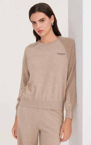 Camel cashmere knit crewneck top with subtle shimmer tab detail and straight hem, long sleeve.