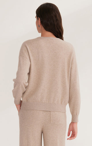 Back view of camel cashmere knit top with crew neck, long sleeves, and straight hemline.