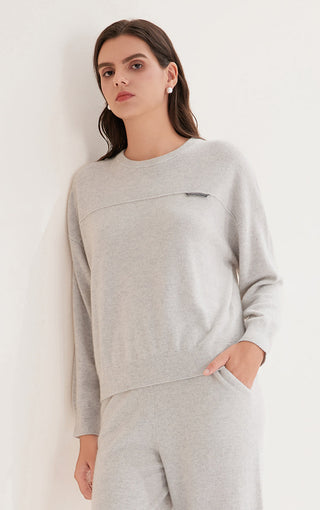 Light gray cashmere knit crewneck top with shimmer accent tab and long sleeves.
