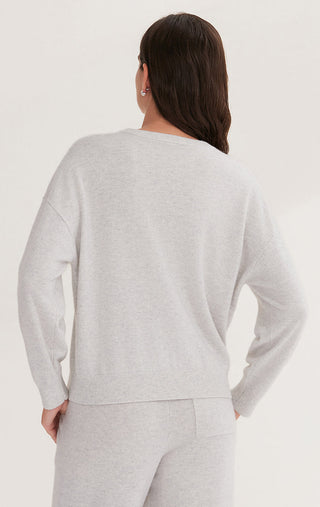 Back view of light gray cashmere knit top with crew neck and long sleeves, straight hemline.