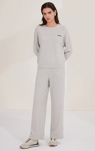 Light gray cashmere knit pants with wide legs and minimal back detailing