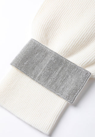 Close-up of contrast cuff band on ivory ribbed knit sleeve