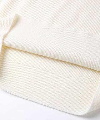 Close-up of ivory sweater hem and ribbed knit fabric