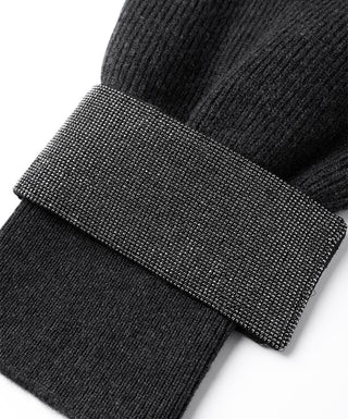 Close-up of beaded chain cuff band on graphite gray ribbed knit sweater sleeve