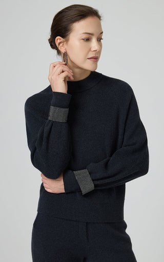 Graphite gray ribbed knit sweater with dark beaded chain cuff at the wrist, crew neck