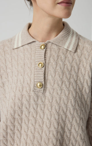 Camel cable-knit wool polo sweater close-up with gold buttons and ribbed collar