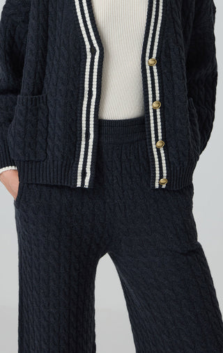 Graphite gray cable-knit pants with wide-leg cut and textured stitch pattern.