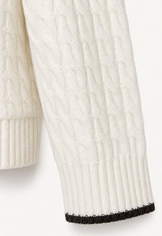 Ivory cable-knit cardigan sleeve with black ribbed cuff trim