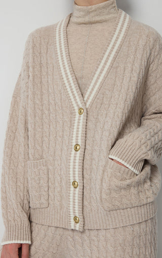 Camel wool cardigan close-up with contrast trim stripes and gold button details