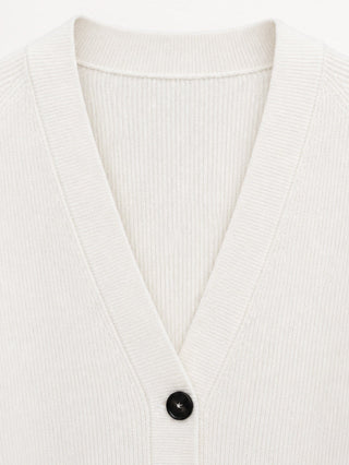 White V-neck cardigan neckline with black button and ribbed knit collar