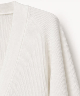 White wool cardigan shoulder with ribbed knit texture and V-neck edge
