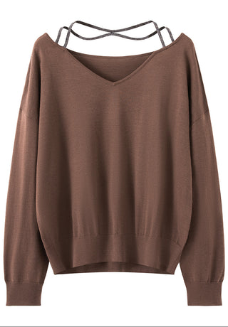 Flat lay of brown V-neck fine wool sweater with beaded open-back straps.
