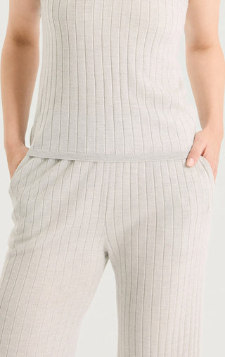 Light gray fine rib knit trousers close-up of ribbed waistband and leg panels.