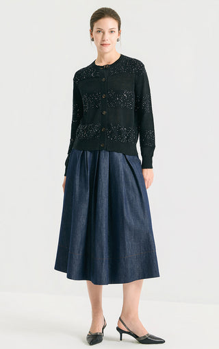 Black sequin-striped linen knit cardigan worn over a midi skirt