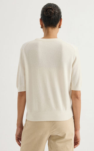 Ivory cashmere short-sleeve sweater, back view with ribbed hem