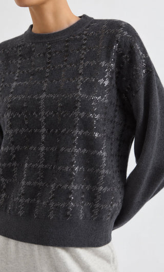 Close-up of dark grey cashmere crewneck sweater with sequin detail across knit