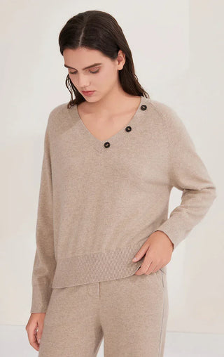 Camel V-neck cashmere sweater with scarf drape and three dark buttons at collar
