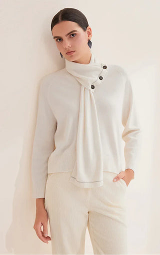 White scarf-neck cashmere sweater with three dark buttons and soft ribbed sleeves