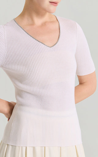 Close-up of white ribbed knit V-neck top with contrast trim