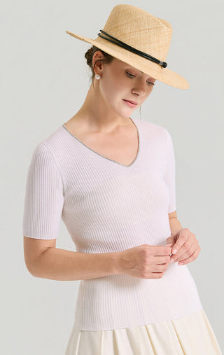White ribbed knit V-neck top with contrast neckline trim, side view