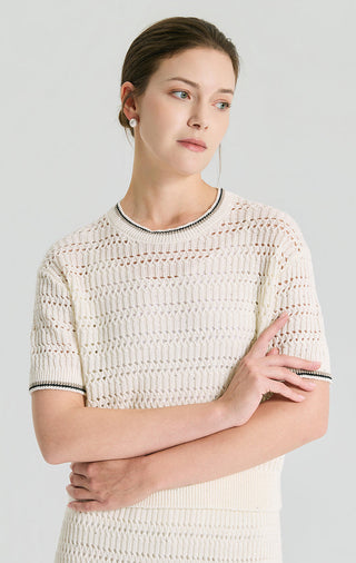 Ivory white open-knit linen top with sequin specks, crew neckline, and ribbed black trim