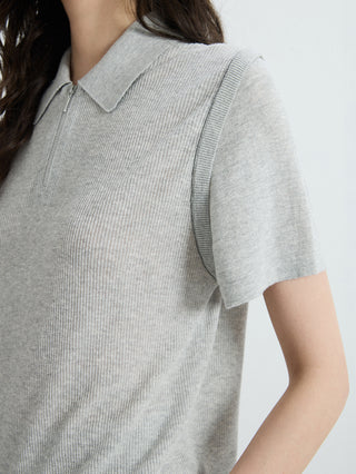 Close-up: gray half-zip polo knit top with ribbed collar and zip placket seam