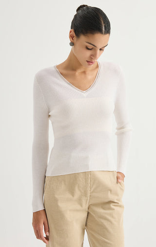 White ribbed wool V-neck sweater with long sleeves, side view.