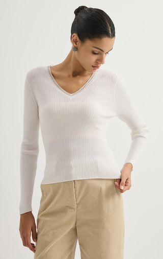 White ribbed wool V-neck sweater with long sleeves.