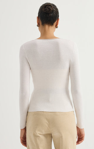 White ribbed wool sweater with long sleeves, crew back.