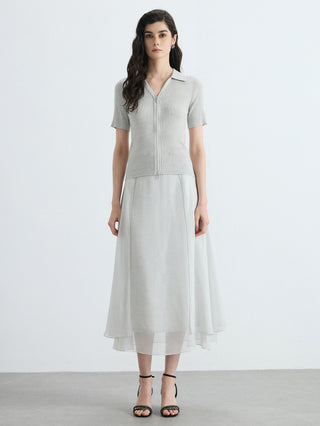 Light gray full-zip ribbed polo knit top with short sleeves, worn over white skirt