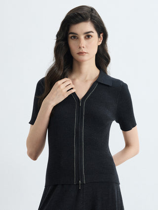 Front view of black ribbed full-zip polo knit top with short sleeves and stand collar