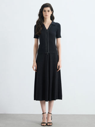 Black ribbed knit full-zip polo top with short sleeves and slim fit over midi skirt