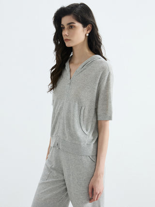 Gray ribbed hooded zip-up top with front zip and pocket detail, short sleeves.